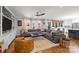 Open-concept living room with a large sectional sofa, built-ins, and access to the kitchen at 4147 Chelmsford Rd, Charlotte, NC 28211