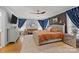Spacious primary bedroom with a sitting area, dark accent wall and large windows at 4147 Chelmsford Rd, Charlotte, NC 28211