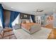 Elegant primary bedroom with a sitting area, dark accent wall and a view to another room at 4147 Chelmsford Rd, Charlotte, NC 28211