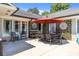 Elegant outdoor dining area with stylish furniture, decorative wall accents, and lush greenery at 4147 Chelmsford Rd, Charlotte, NC 28211