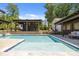Inviting backyard pool with tanning ledge, pergola, and outdoor seating area at 4147 Chelmsford Rd, Charlotte, NC 28211
