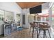 Inviting sunroom boasts a TV, bar, and comfortable seating for relaxation and entertainment at 4147 Chelmsford Rd, Charlotte, NC 28211