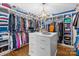 Spacious walk-in closet with custom shelving, ample storage, and a decorative chandelier at 4147 Chelmsford Rd, Charlotte, NC 28211