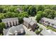 Aerial view showcases well-maintained townhomes with brick facades and grey roofs within a leafy neighborhood at 4941 S Hill View Dr, Charlotte, NC 28210