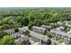 An aerial view displays an enclave of brick townhomes enveloped by lush, mature trees at 4941 S Hill View Dr, Charlotte, NC 28210