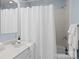 Bright bathroom with single sink, white countertop, and a shower/tub combo at 4941 S Hill View Dr, Charlotte, NC 28210
