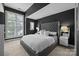 Modern bedroom with dark walls, plush carpet, a tufted headboard, and stylish bedside tables at 4941 S Hill View Dr, Charlotte, NC 28210