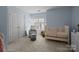 Cozy Bedroom with a white crib, chair, soft carpet, and natural light streaming through the window at 4941 S Hill View Dr, Charlotte, NC 28210