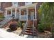 Inviting front entrance with brick steps, a wrought iron railing, and manicured landscaping at 4941 S Hill View Dr, Charlotte, NC 28210