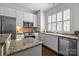 Bright kitchen features white cabinetry, stainless steel appliances, granite counters, and a kitchen island for added space at 4941 S Hill View Dr, Charlotte, NC 28210