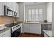 Well-lit kitchen showcasing stainless steel appliances, light cabinets, granite countertops, and an undermount sink at 4941 S Hill View Dr, Charlotte, NC 28210