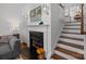 Modern fireplace with black marble, gray couch, and hardwood floors at 4941 S Hill View Dr, Charlotte, NC 28210