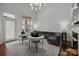 Bright living room with hardwood floors, a gray couch, and stylish decor at 4941 S Hill View Dr, Charlotte, NC 28210