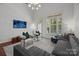 Bright living room with hardwood floors, a gray couch, and stylish decor at 4941 S Hill View Dr, Charlotte, NC 28210