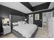 Comfortable main bedroom with dark walls, carpet, an ensuite bath, and a walk-in closet at 4941 S Hill View Dr, Charlotte, NC 28210