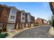 A street view of well-maintained brick townhouses with garages and neat landscaping at 4941 S Hill View Dr, Charlotte, NC 28210