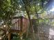 Wood deck accessible by wooden stairs, surrounded by mature trees and lush greenery at 500 W Council St, Salisbury, NC 28144