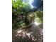Backyard with mature trees, a brick patio, and stairs leading to a deck at 500 W Council St, Salisbury, NC 28144