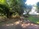 Lush backyard featuring a brick patio, fountain, and mature trees providing shade at 500 W Council St, Salisbury, NC 28144