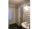 Bathroom showcasing patterned wallpaper, green-tiled flooring, and a white vanity at 500 W Council St, Salisbury, NC 28144
