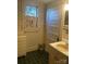 Bathroom featuring patterned wallpaper, black-tiled flooring, and a white vanity at 500 W Council St, Salisbury, NC 28144