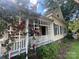 Beautiful yellow home featuring a wraparound porch adorned with climbing red roses at 500 W Council St, Salisbury, NC 28144