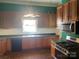 Traditional kitchen with wood cabinets, black countertops, and stainless steel microwave at 500 W Council St, Salisbury, NC 28144