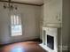 Living room boasts a tiled fireplace, built-in shelving, hardwood floors, and natural light at 500 W Council St, Salisbury, NC 28144