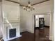 Living room featuring original hardwood floors, decorative fireplace, and classic chandelier at 500 W Council St, Salisbury, NC 28144