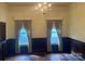 Living room featuring traditional wainscoting, hardwood floors, and classic lighting fixtures at 500 W Council St, Salisbury, NC 28144