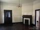 Cozy living room with hardwood floors, a traditional fireplace, and classic lighting fixture at 500 W Council St, Salisbury, NC 28144