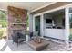 Inviting outdoor patio featuring a stone fireplace and comfortable seating, perfect for relaxation at 503 Meadow Ridge Dr, Belmont, NC 28012
