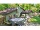Landscaped backyard with a dining area, outdoor seating, and grill, perfect for entertaining at 7357 Elwood Dr, Charlotte, NC 28227