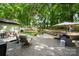 Expansive backyard with various seating areas and mature trees, ideal for relaxation and entertaining at 7357 Elwood Dr, Charlotte, NC 28227