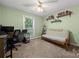 Charming bedroom featuring a cozy futon and shelves adorned with books, creating a relaxing space at 7357 Elwood Dr, Charlotte, NC 28227