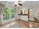 Bright dining area with large windows, wood flooring, and a view of the bar and living space at 7357 Elwood Dr, Charlotte, NC 28227