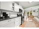 Modern kitchen featuring white cabinets, granite countertops, stainless steel appliances, and an open layout at 7357 Elwood Dr, Charlotte, NC 28227