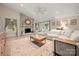 Bright living room featuring a stone fireplace, wood floors, and a comfortable sofa at 7357 Elwood Dr, Charlotte, NC 28227