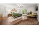 Stylish main bedroom with wood floors, decorative lighting, and a large bed at 7357 Elwood Dr, Charlotte, NC 28227