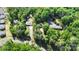 An aerial view showing the property nestled among lush trees and well-maintained neighboring homes at 7525 Cedarbrook Dr, Charlotte, NC 28215