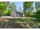 A spacious backyard features a well-maintained lawn, mature trees, and plenty of space for outdoor activities at 7525 Cedarbrook Dr, Charlotte, NC 28215