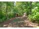 A spacious backyard featuring mature trees and outbuildings at 7525 Cedarbrook Dr, Charlotte, NC 28215