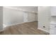 Spacious basement area with neutral walls, wood-look flooring and a door for easy access at 7525 Cedarbrook Dr, Charlotte, NC 28215