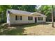 Charming one-story home with a welcoming entrance, well-kept lawn, and mature landscaping at 7525 Cedarbrook Dr, Charlotte, NC 28215