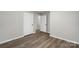 Bright hallway with wood-look flooring and multiple doorways at 7525 Cedarbrook Dr, Charlotte, NC 28215