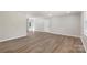 Bright living room featuring newly installed wood floors, fresh paint and plenty of natural light at 7525 Cedarbrook Dr, Charlotte, NC 28215
