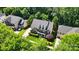 Aerial view of a brick home surrounded by lush landscaping and mature trees at 7722 Garnkirk Dr, Huntersville, NC 28078