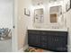 Bathroom boasts dual sinks with a dark wood vanity, shiplap walls, and recessed lighting at 7722 Garnkirk Dr, Huntersville, NC 28078