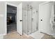 Bathroom featuring a frameless glass shower, neutral tile, and white doors at 7722 Garnkirk Dr, Huntersville, NC 28078