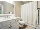 Clean bathroom featuring a white vanity, a fish decoration, and a shower with a white curtain at 7722 Garnkirk Dr, Huntersville, NC 28078